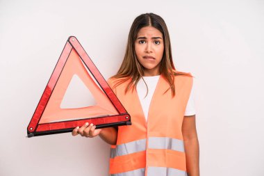 hispanic pretty woman looking puzzled and confused. car accident emergency concept