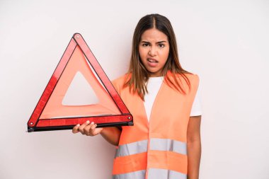 hispanic pretty woman feeling puzzled and confused. car accident emergency concept