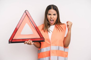 hispanic pretty woman shouting aggressively with an angry expression. car accident emergency concept