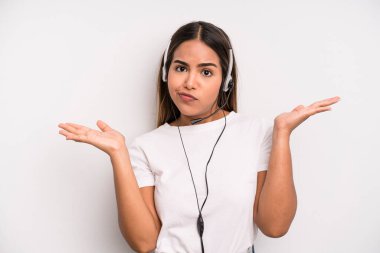 hispanic pretty woman feeling puzzled and confused and doubting. telemarketer concept
