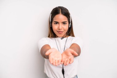 hispanic pretty woman smiling happily with friendly and  offering and showing a concept. telemarketer concept