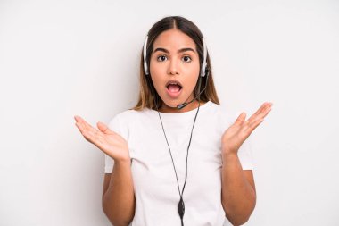 hispanic pretty woman feeling happy and astonished at something unbelievable. telemarketer concept