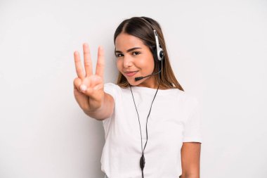 hispanic pretty woman smiling and looking friendly, showing number three. telemarketer concept