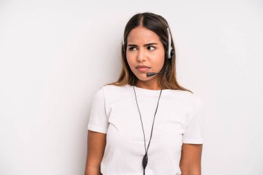 hispanic pretty woman feeling sad, upset or angry and looking to the side. telemarketer concept