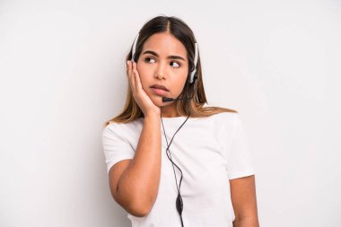 hispanic pretty woman feeling bored, frustrated and sleepy after a tiresome. telemarketer concept