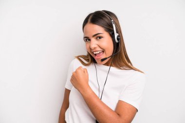 hispanic pretty woman feeling happy and facing a challenge or celebrating. telemarketer concept
