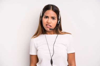 hispanic pretty woman feeling puzzled and confused. telemarketer concept