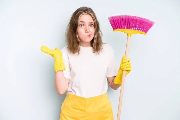 caucasian pretty woman feeling puzzled and confused and doubting. housekeeper cleaning concept