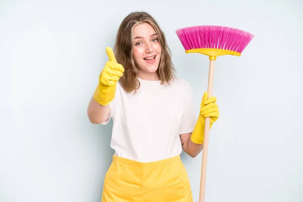 caucasian pretty woman feeling proud,smiling positively with thumbs up. housekeeper cleaning concept