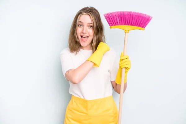 caucasian pretty woman feeling happy and facing a challenge or celebrating. housekeeper cleaning concept