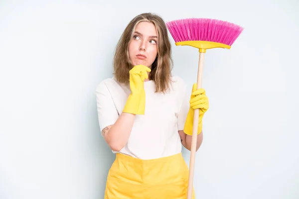 caucasian pretty woman thinking, feeling doubtful and confused. housekeeper cleaning concept