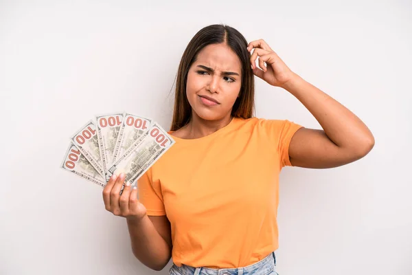 Hispanic Pretty Woman Feeling Puzzled Confused Scratching Head Dollar Banknotes — Foto Stock