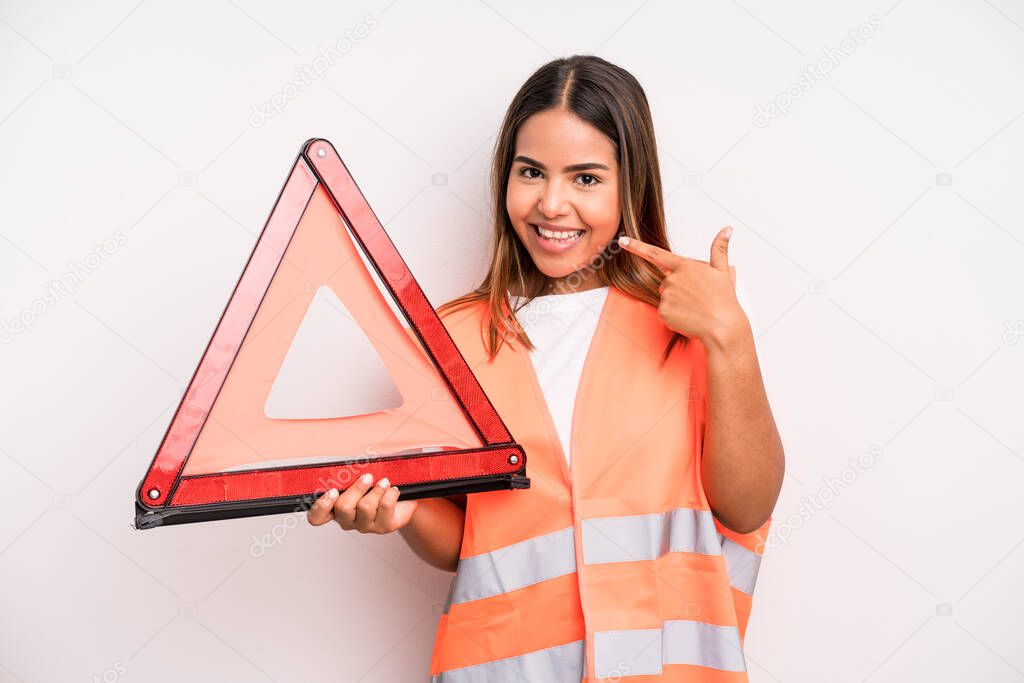 hispanic pretty woman smiling confidently pointing to own broad smile. car accident emergency concept