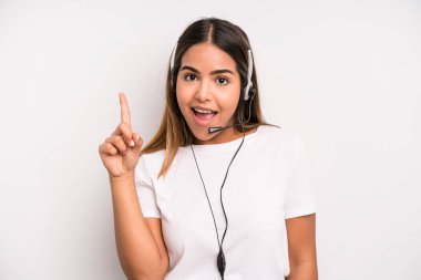 hispanic pretty woman feeling like a happy and excited genius after realizing an idea. telemarketer concept