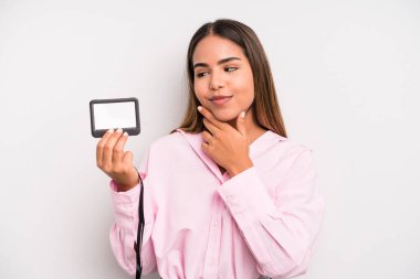hispanic pretty woman smiling with a happy, confident expression with hand on chin. pass id card concept