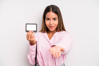 hispanic pretty woman smiling happily with friendly and  offering and showing a concept. pass id card concept