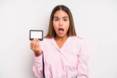 hispanic pretty woman looking very shocked or surprised. pass id card concept