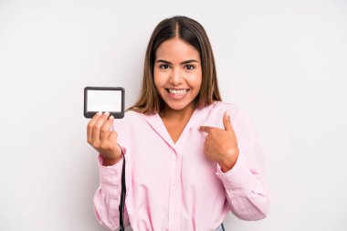 hispanic pretty woman feeling happy and pointing to self with an excited. pass id card concept