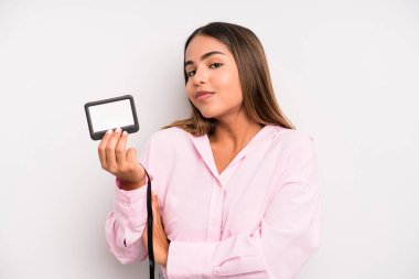 hispanic pretty woman shrugging, feeling confused and uncertain. pass id card concept