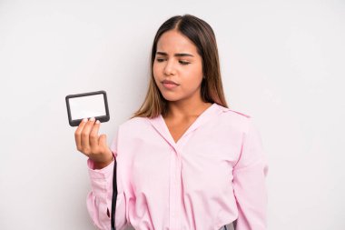 hispanic pretty woman feeling sad, upset or angry and looking to the side. pass id card concept