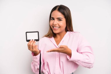 hispanic pretty woman smiling cheerfully, feeling happy and showing a concept. pass id card concept