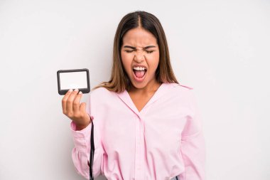 hispanic pretty woman shouting aggressively, looking very angry. pass id card concept