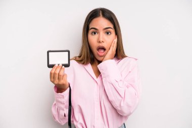 hispanic pretty woman feeling shocked and scared. pass id card concept