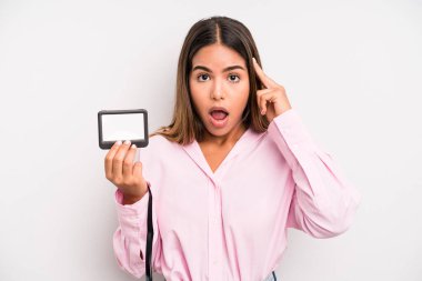 hispanic pretty woman looking surprised, realizing a new thought, idea or concept. pass id card concept