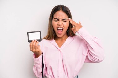 hispanic pretty woman looking unhappy and stressed, suicide gesture making gun sign. pass id card concept