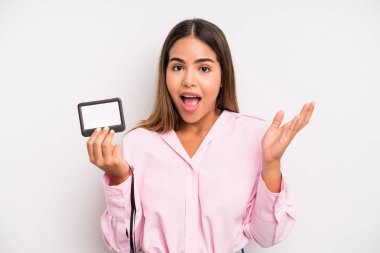 hispanic pretty woman feeling happy, surprised realizing a solution or idea. pass id card concept
