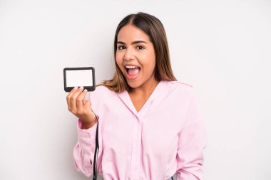 hispanic pretty woman looking happy and pleasantly surprised. pass id card concept