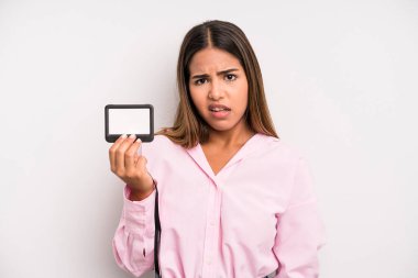 hispanic pretty woman feeling puzzled and confused. pass id card concept