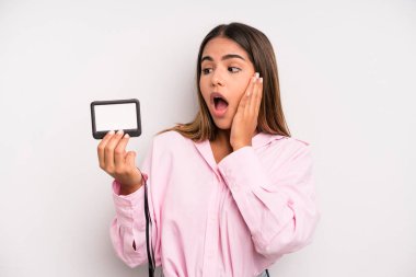 hispanic pretty woman feeling happy, excited and surprised. pass id card concept