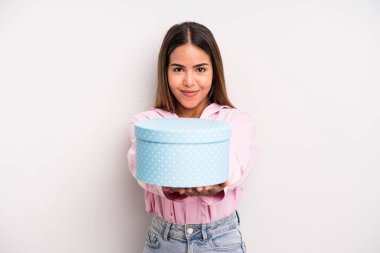 hispanic pretty woman smiling happily with friendly and  offering and showing a concept. gift box concept