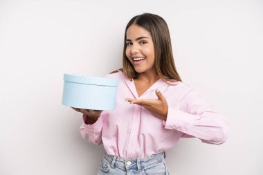 hispanic pretty woman smiling cheerfully, feeling happy and showing a concept. gift box concept