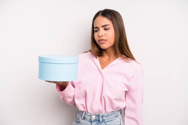 hispanic pretty woman feeling sad, upset or angry and looking to the side. gift box concept