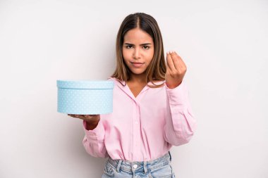 hispanic pretty woman making capice or money gesture, telling you to pay. gift box concept