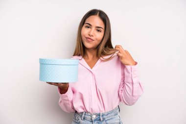 hispanic pretty woman looking arrogant, successful, positive and proud. gift box concept