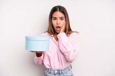 hispanic pretty woman feeling shocked and scared. gift box concept