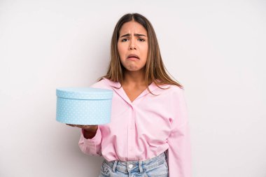 hispanic pretty woman feeling sad and whiney with an unhappy look and crying. gift box concept