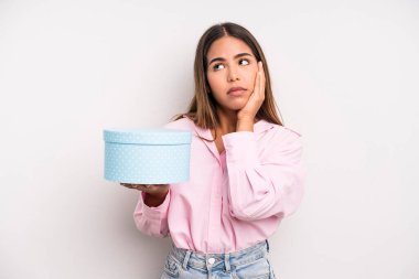 hispanic pretty woman feeling bored, frustrated and sleepy after a tiresome. gift box concept