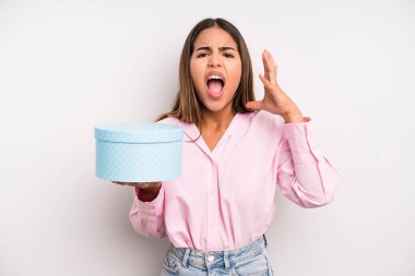 hispanic pretty woman screaming with hands up in the air. gift box concept