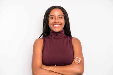 black young adult woman looking like a happy, proud and satisfied achiever smiling with arms crossed
