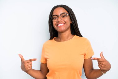 black young adult woman looking proud, arrogant, happy, surprised and satisfied, pointing to self, feeling like a winner