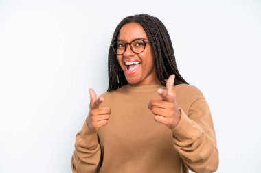 black young adult woman smiling with a positive, successful, happy attitude pointing to the camera, making gun sign with hands