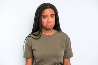 black young adult woman feeling sad and stressed, upset because of a bad surprise, with a negative, anxious look