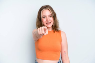 caucasian pretty woman pointing at camera with a satisfied, confident, friendly smile, choosing you