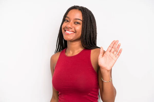 Black Young Adult Woman Smiling Happily Cheerfully Waving Hand Welcoming — Stok fotoğraf