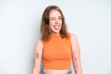 caucasian pretty woman with cheerful, carefree, rebellious attitude, joking and sticking tongue out, having fun