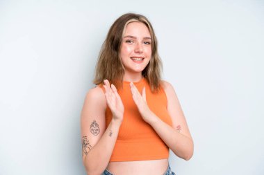 caucasian pretty woman feeling happy and successful, smiling and clapping hands, saying congratulations with an applause